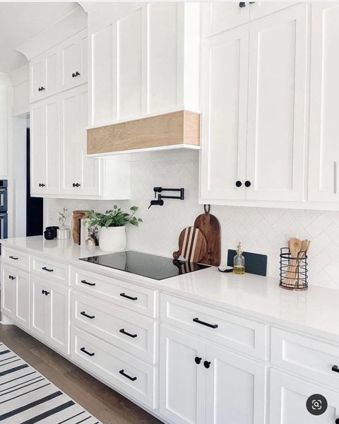 Classic white kitchen remodel with glass-front upper cabinets in Hyde Park.